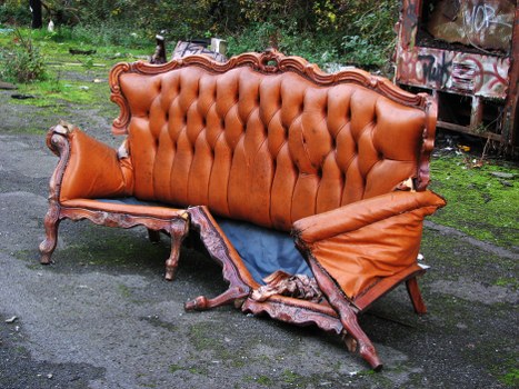 Waste collection crew briefing beside commercial bins